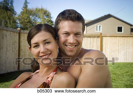 Couple embracing in yard View Large Photo Image Stock Image - Couple embracing in yard. Fotosearch