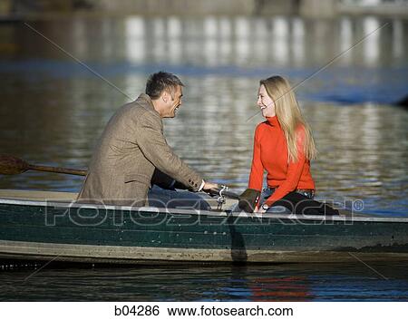 Couple in canoe laughing View Large Photo Image Stock Photograph - Couple in canoe laughing. Fotosearch