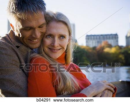 Couple sitting by water View Large Photo Image Stock Image - Couple sitting by water. Fotosearch