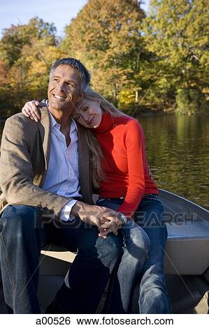 Couple sitting in canoe View Large Photo Image Stock Photograph - Couple sitting in canoe. Fotosearch