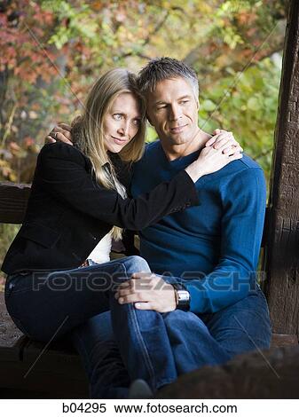 Couple sitting on bench View Large Photo Image Stock Photography - Couple sitting on bench. Fotosearch