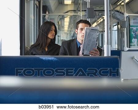 Stock Image - Couple sitting on bus or subway. Fotosearch