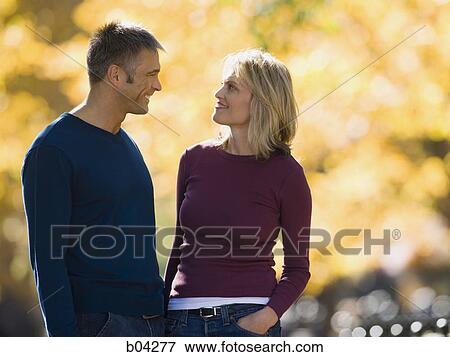 Couple standing outdoors View Large Photo Image Stock Photo - Couple standing outdoors. Fotosearch