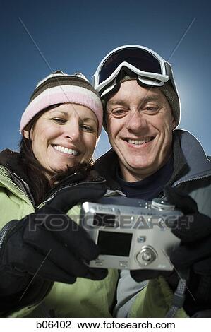Couple using a camera outside View Large Photo Image Stock Image - Couple using a camera outside. Fotosearch