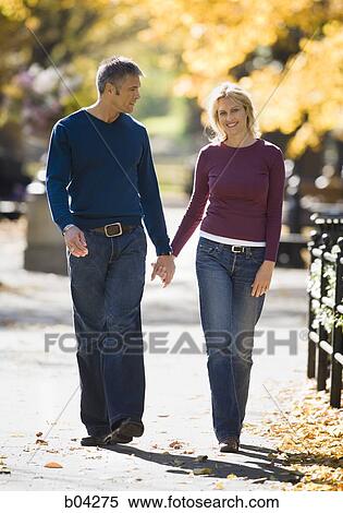 Couple walking outdoors View Large Photo Image Stock Photography - Couple walking outdoors. Fotosearch