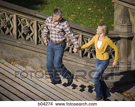 Couple walking up stairs View Large Photo Image Picture - Couple walking up stairs. Fotosearch