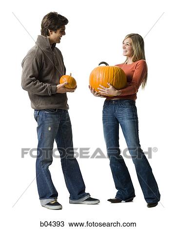 Couple with pumpkins View Large Photo Image Stock Image - Couple with pumpkins. Fotosearch