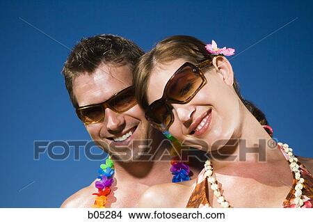 Couple with sunglasses and blue sky View Large Photo Image Picture - Couple with sunglasses and blue sky. Fotosearch
