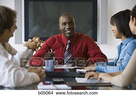 Discussion at business meeting smiling View Large Photo Image Picture - Discussion at business meeting smiling. Fotosearch