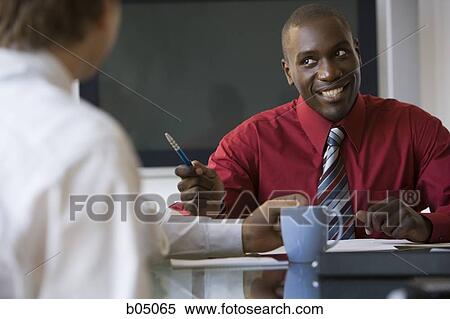 Discussion at business meeting smiling View Large Photo Image Stock Photography - Discussion at business meeting smiling. Fotosearch