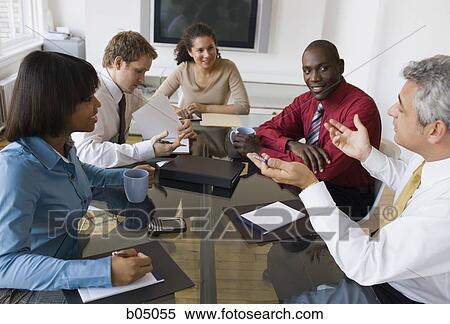 Discussion at business meeting with five people View Large Photo Image Stock Photography - Discussion at business meeting with five people. Fotosearch