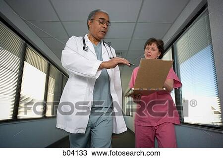 Doctor and nurse consulting chart View Large Photo Image Stock Image - Doctor and nurse consulting chart. Fotosearch