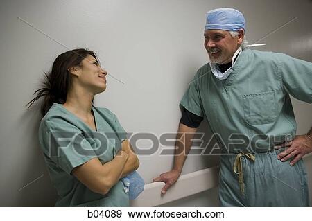 Doctor and nurse in scrubs talking View Large Photo Image Stock Photo - Doctor and nurse in scrubs talking. Fotosearch