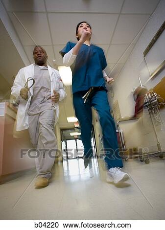 Doctor and nurse rushing through corridor View Large Photo Image Stock Image - Doctor and nurse rushing through corridor. Fotosearch