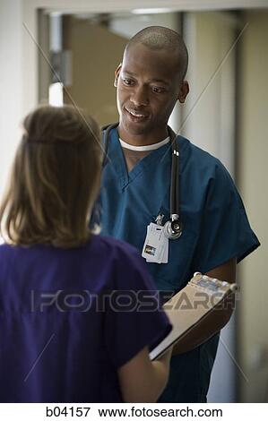 Doctor and nurse talking View Large Photo Image Stock Photo - Doctor and nurse talking. Fotosearch