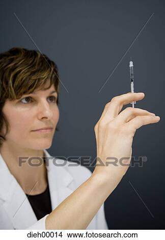 Doctor with syringe View Large Photo Image Picture - Doctor with syringe. Fotosearch