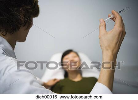 Doctor with syringe View Large Photo Image Stock Photograph - Doctor with syringe. Fotosearch