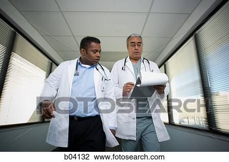 Doctors walking and talking View Large Photo Image Stock Image - Doctors walking and talking. Fotosearch
