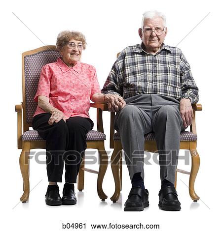 Elderly couple in armchairs holding hands View Large Photo Image Stock Image - Elderly couple in armchairs holding hands. Fotosearch