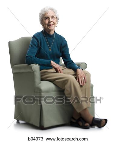 Elderly woman sitting in an armchair smiling View Large Photo Image Stock Image - Elderly woman sitting in an armchair smiling. Fotosearch