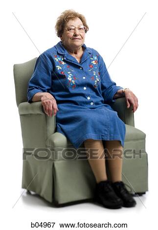 Elderly woman sitting in an armchair View Large Photo Image Stock Photo - Elderly woman sitting in an armchair. Fotosearch