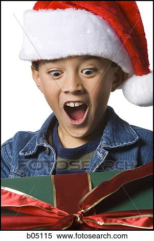 Excited boy with Christmas gift View Large Photo Image Stock Photography - Excited boy with Christmas gift. Fotosearch