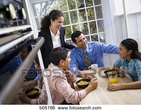Family at breakfast table smiling View Large Photo Image Stock Photograph - Family at breakfast table smiling. Fotosearch