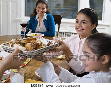 Family at dinner table smiling View Large Photo Image Picture - Family at dinner table smiling. Fotosearch