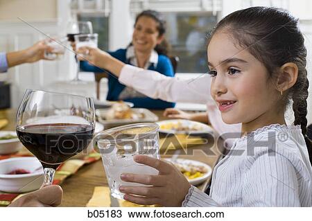 Family at dinner table toasting View Large Photo Image Stock Image - Family at dinner table toasting. Fotosearch