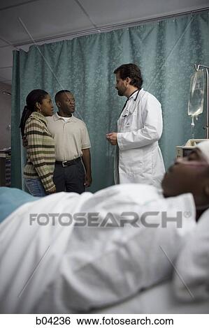 Family of boy in hospital bed talking with doctor View Large Photo Image Stock Photograph - Family of boy in hospital bed talking with doctor. Fotosearch
