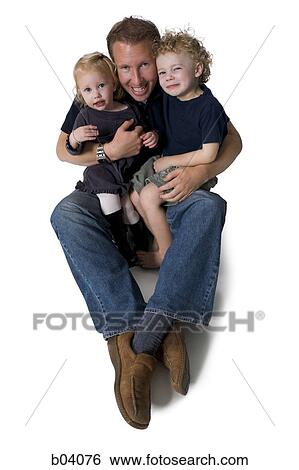Father sitting with young children in lap View Large Photo Image Stock Photograph - Father sitting with young children in lap. Fotosearch