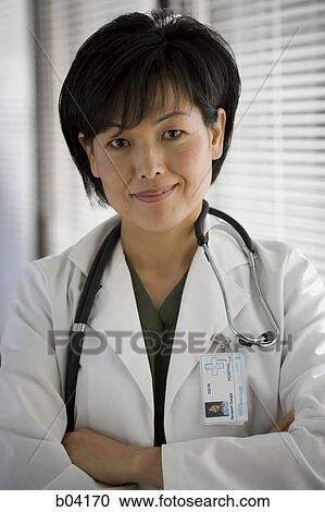Female doctor posing with arms crossed View Large Photo Image Stock Image - Female doctor posing with arms crossed. Fotosearch