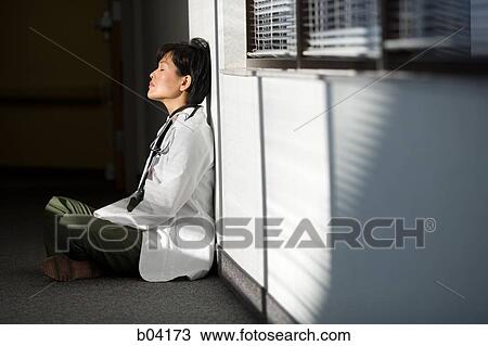 Female Doctor resting with legs crossed View Large Photo Image Stock Image - Female Doctor resting with legs crossed. Fotosearch