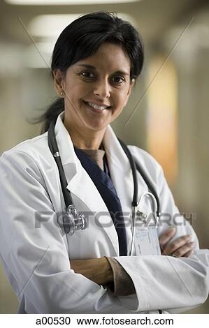 Female doctor smiling with arms crossed View Large Photo Image Stock Image - Female doctor smiling with arms crossed. Fotosearch