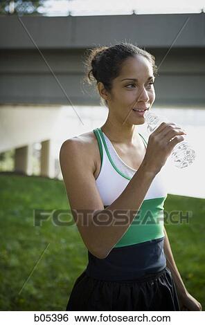 Female drinking bottle of water View Large Photo Image Stock Photograph - Female drinking bottle of water. Fotosearch