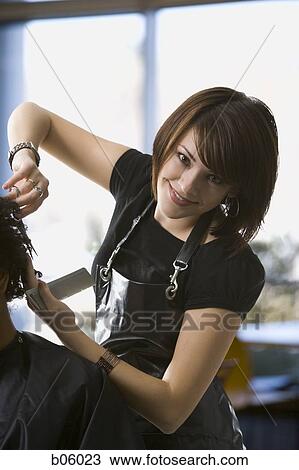 Female hairdresser cutting hair View Large Photo Image Stock Image - Female hairdresser cutting hair. Fotosearch