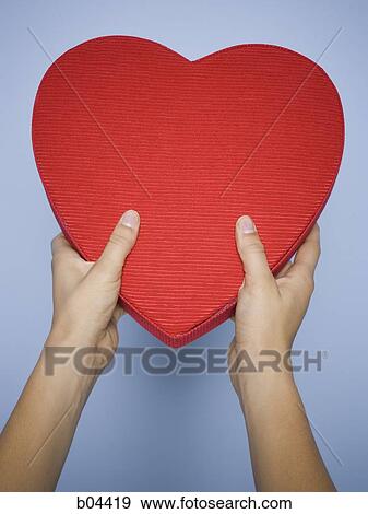 Female hands holding red heart View Large Photo Image Stock Photo - Female hands holding red heart. Fotosearch