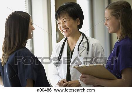 Female hospital staff talking View Large Photo Image Stock Photograph - Female hospital staff talking. Fotosearch