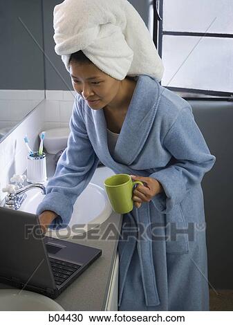 Female in bathroom with laptop View Large Photo Image Stock Image - Female in bathroom with laptop. Fotosearch
