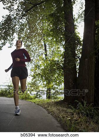 Female jogger in forest View Large Photo Image Picture - Female jogger in forest. Fotosearch