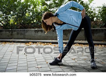 Female jogger stretching View Large Photo Image Stock Photography - Female jogger stretching. Fotosearch