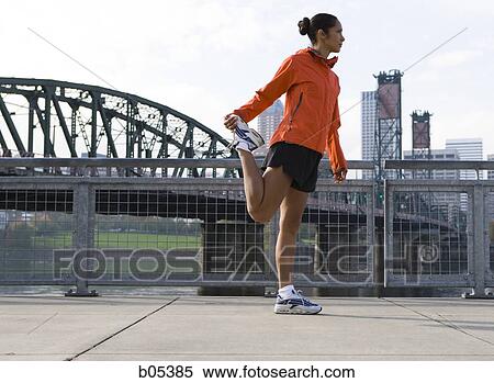 Female jogger stretching View Large Photo Image Stock Photography - Female jogger stretching. Fotosearch