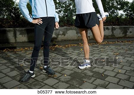 Female joggers stretching View Large Photo Image Stock Photo - Female joggers stretching. Fotosearch