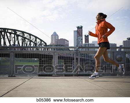 Female jogging in city View Large Photo Image Stock Photograph - Female jogging in city. Fotosearch