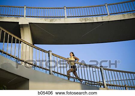 Female jogging on bridge View Large Photo Image Stock Photograph - Female jogging on bridge. Fotosearch