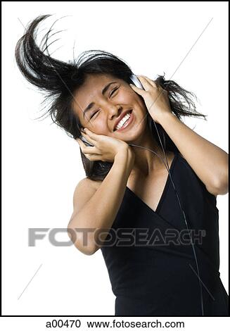 Stock Image - Female listening to music. Fotosearch