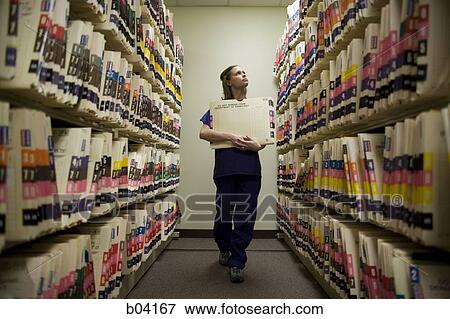 Female nurse filing patient records View Large Photo Image Stock Photo - Female nurse filing patient records. Fotosearch