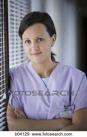 Female nurse leaning on blinds View Large Photo Image Stock Photo - Female nurse leaning on blinds. Fotosearch