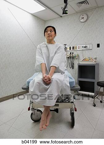 Female patient waiting anxiously in examining room View Large Photo Image Stock Photo - Female patient waiting anxiously in examining room. Fotosearch