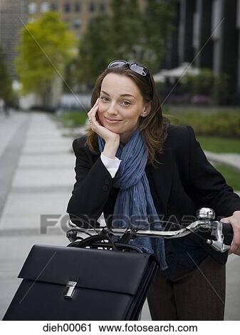 Stock Image - Female with bicycle. Fotosearch